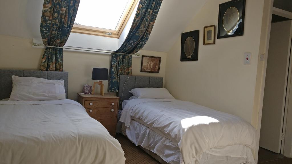 Twin bedroom, containing two single beds, and a roof window.
